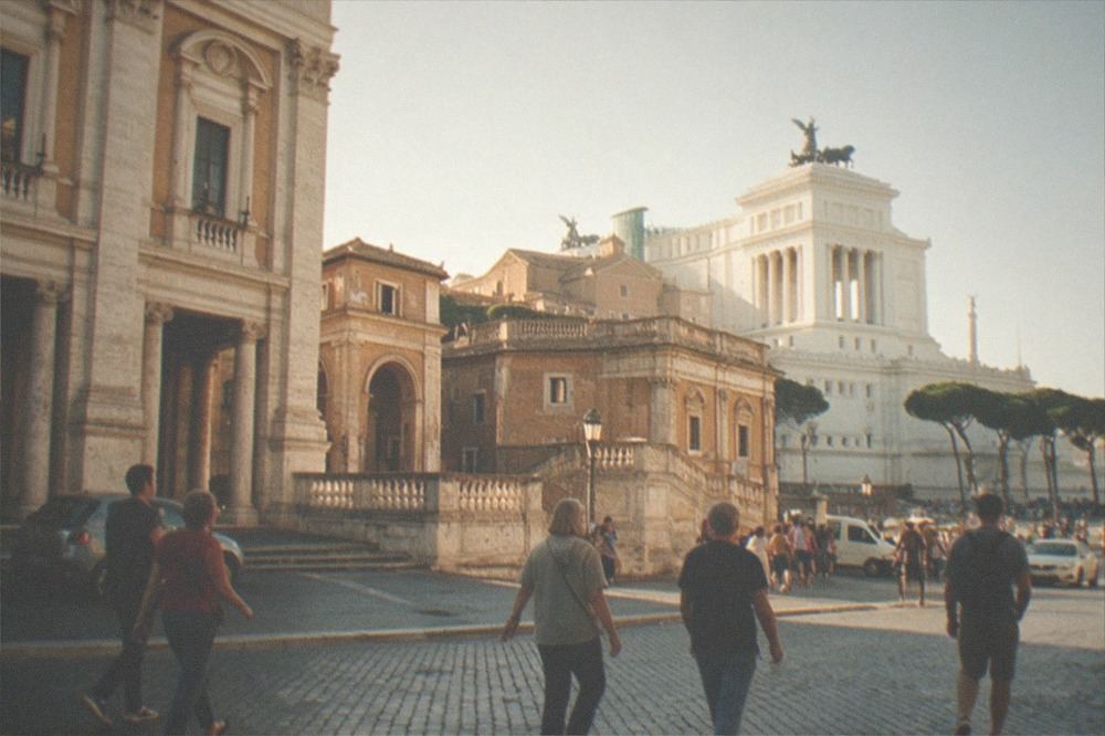 Travertine-clad classical buildings near Piazza Venezia in warm late-afternoon light