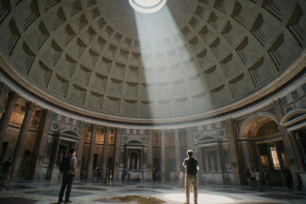 The coffered concrete dome of the Pantheon seen from below with light falling through the oculus