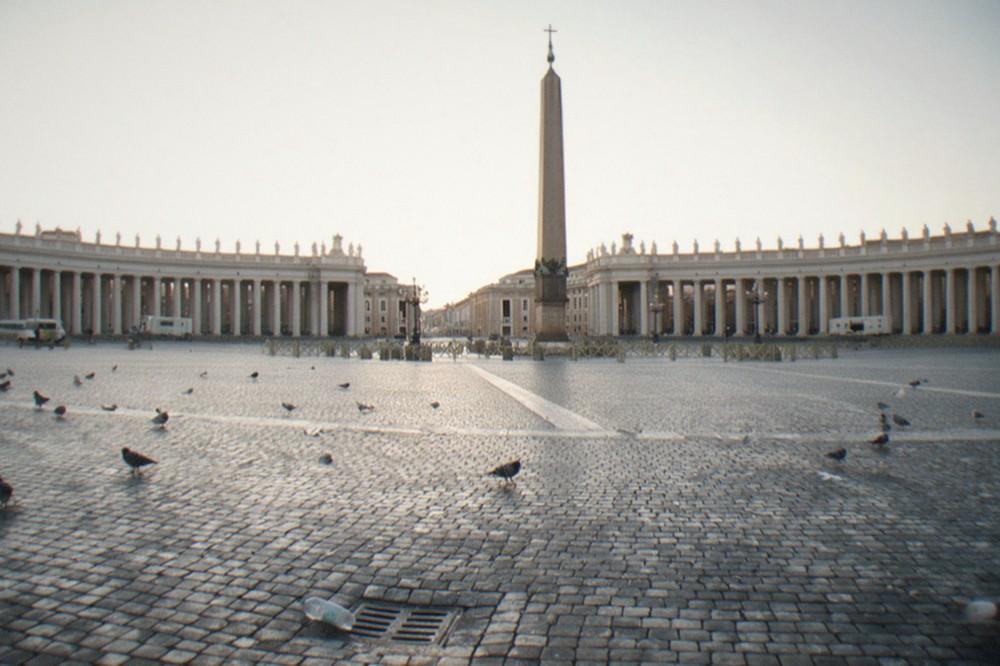 Empty St Peter's Square at dawn with the obelisk and colonnade in soft light