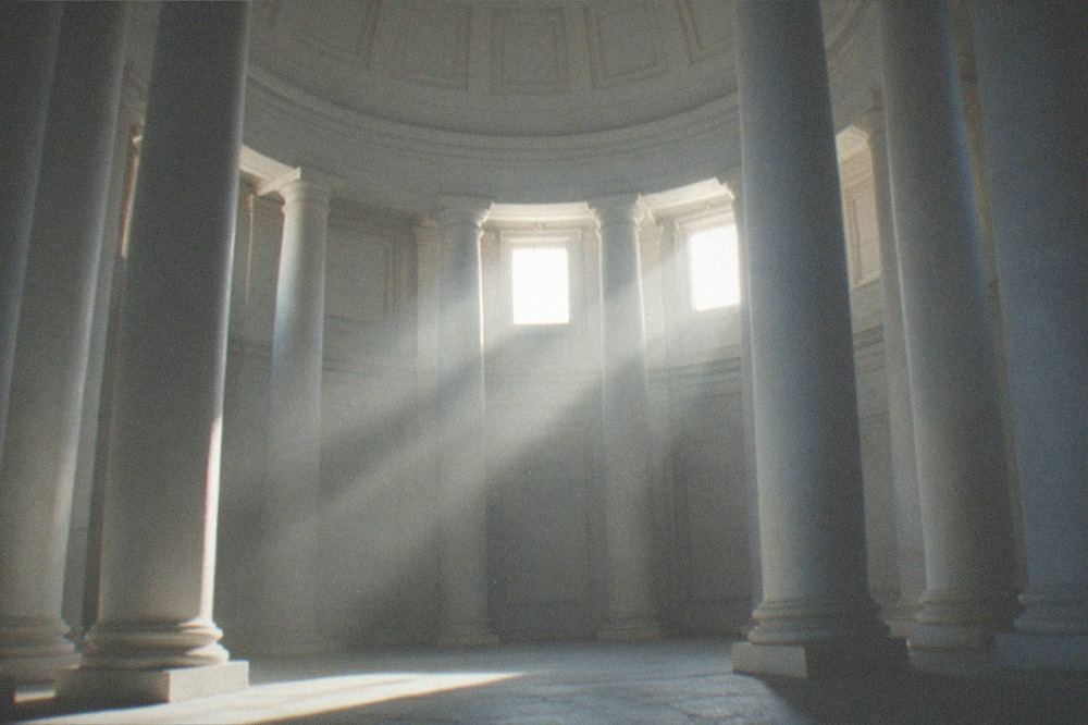 A wide stone basilica interior with columns and soft light from high windows