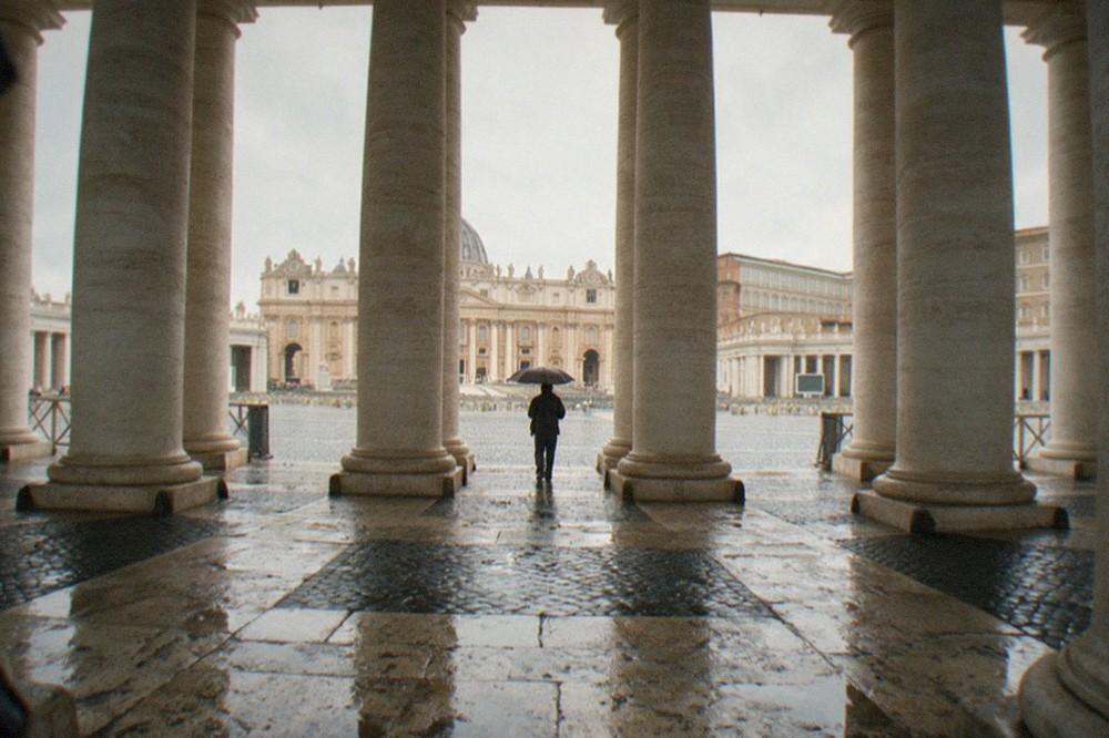 View across St Peter's Square toward the basilica facade with rows of columns