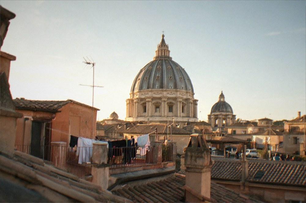 Dome of St Peter's Basilica rising above the rooftops of central Rome