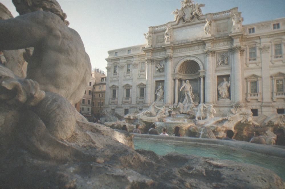 Close view of the travertine stone and carved figures at the base of the Trevi Fountain