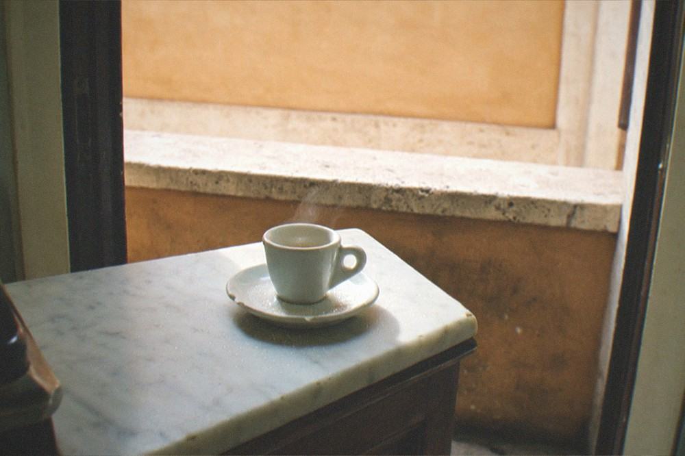 Espresso cup on a marble bar counter in a Roman cafe